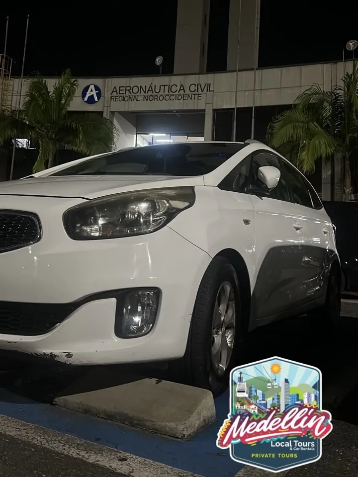 White Kia at José María Córdova airport at night