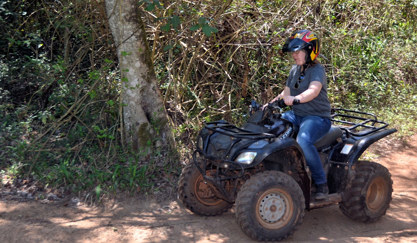 Riding an ATV on a forest trail