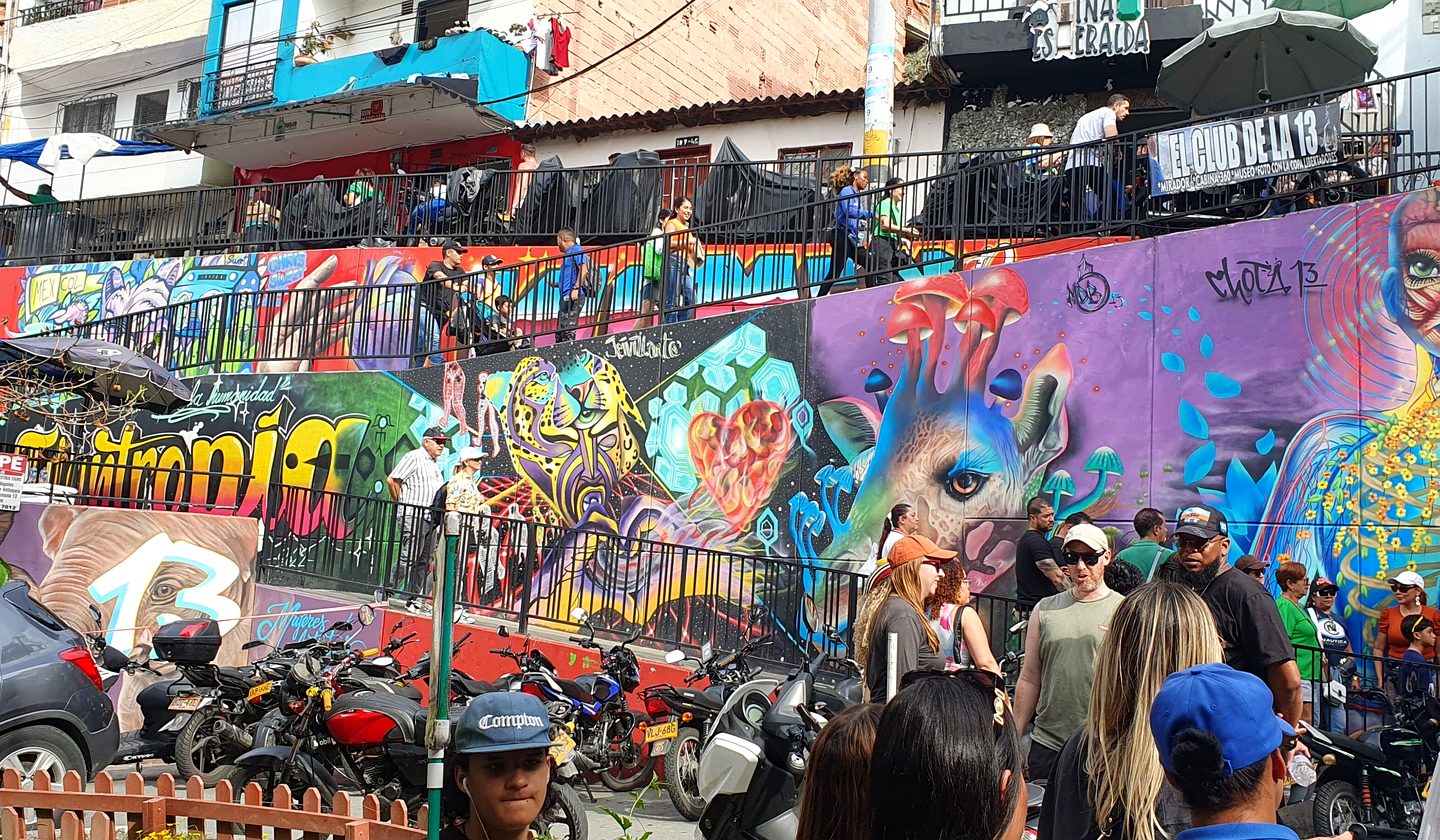 Colorful murals and visitors in Comuna 13