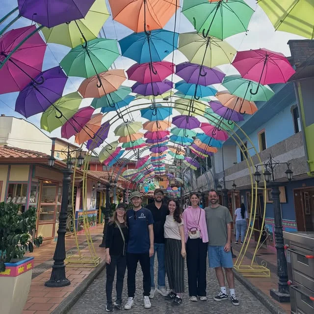 Group tour on an umbrella-covered street